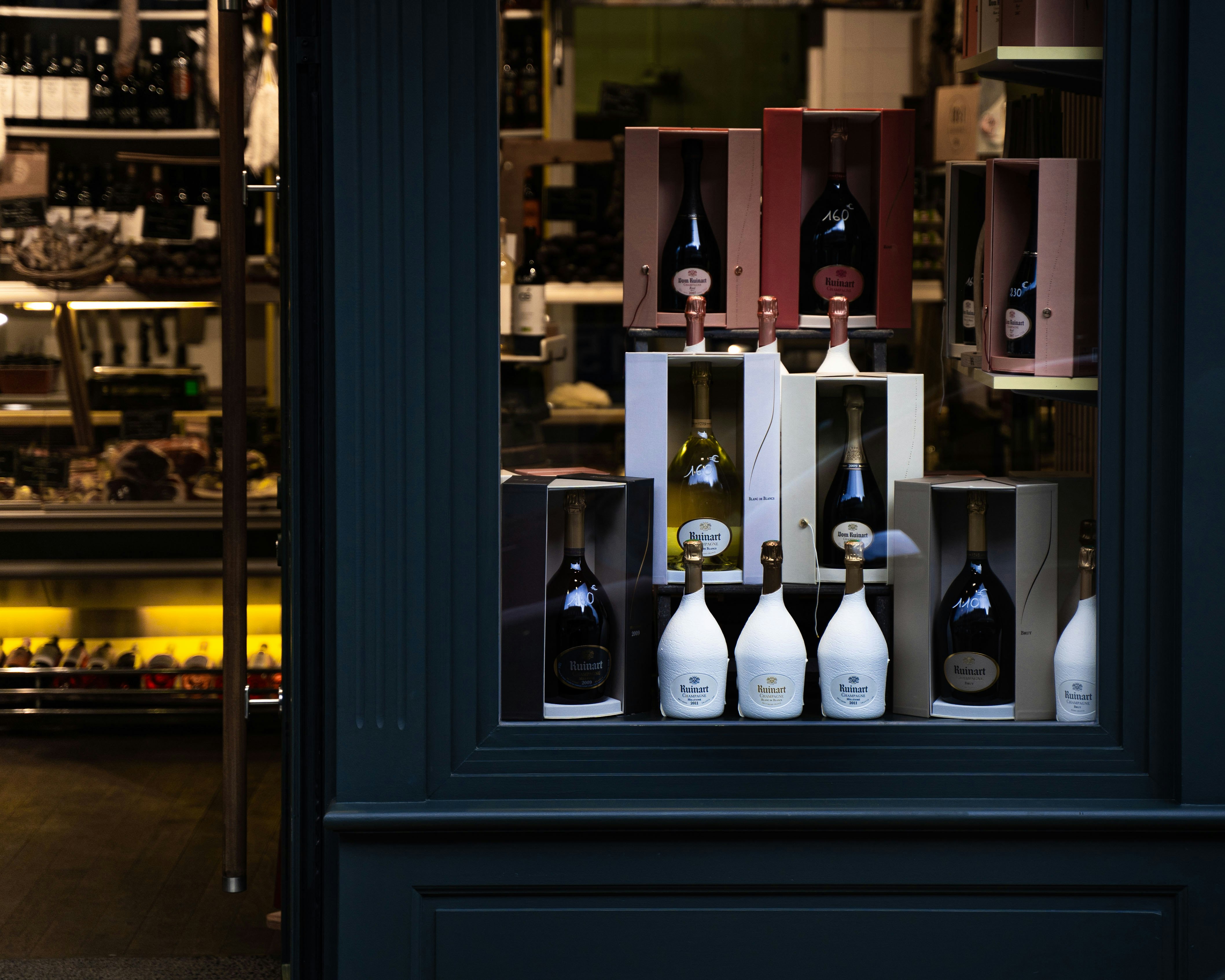 wine bottles on black wooden shelf